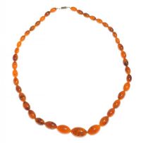 STRING OF GRADUATED FAUX BUTTERSCOTCH AMBER BEADS WITH METAL CLASP at Ross's Online Art Auctions