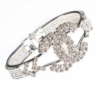 WHITE METAL AND CRYSTAL BANGLE IN THE STYLE OF CHANEL at Ross's Online Art Auctions