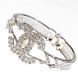 WHITE METAL AND CRYSTAL BANGLE IN THE STYLE OF CHANEL at Ross's Online Art Auctions