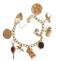 18CT GOLD CHARM BRACELET WITH 9CT GOLD AND 18CT GOLD CHARMS at Ross's Online Art Auctions