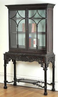 19TH CENTURY CARVED MAHOGANY TWO DOOR BOOKCASE ON CARVED & PIERCED SIDE TABLE WITH FOUR PILLAR LEGS at Ross's Online Art Auctions