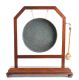 EDWARDIAN MAHOGANY FRAMED DINNER GONG ON A BOX BASE & BUN FEET WITH A BRASS GONG & BEATER at Ross's Online Art Auctions