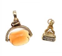 TWO GOLD-TONE PENDANTS at Ross's Online Art Auctions