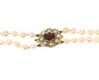 GRADUATED DOUBLE STRING OF PEARLS WITH A 9CT GOLD GARNET CLASP at Ross's Online Art Auctions