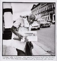 NEWSPAPER SELLER IN HAVANA, CUBA by John Minihan at Ross's Online Art Auctions