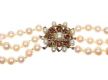 TRIPLE STRAND OF CULTURED PEARLS WITH 9CT GOLD GARNET CLASP at Ross's Online Art Auctions