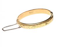 GOLD TONE ENGRAVED BANGLE at Ross's Online Art Auctions