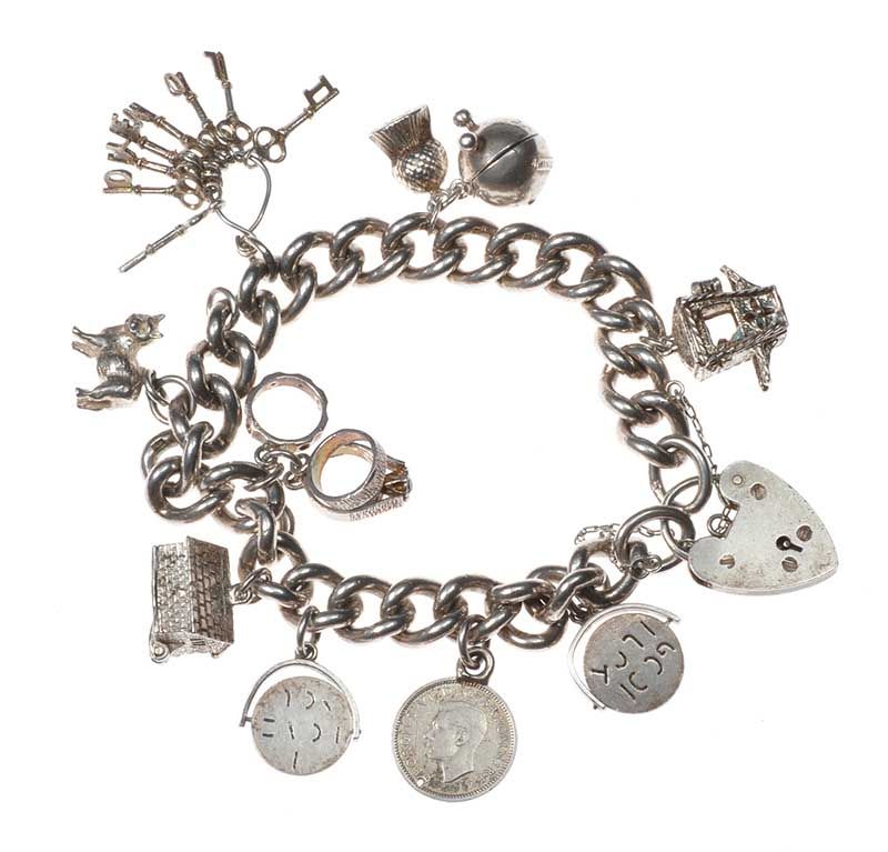 HEAVY STERLING SILVER CHARM BRACELET WITH TEN CHARMS
